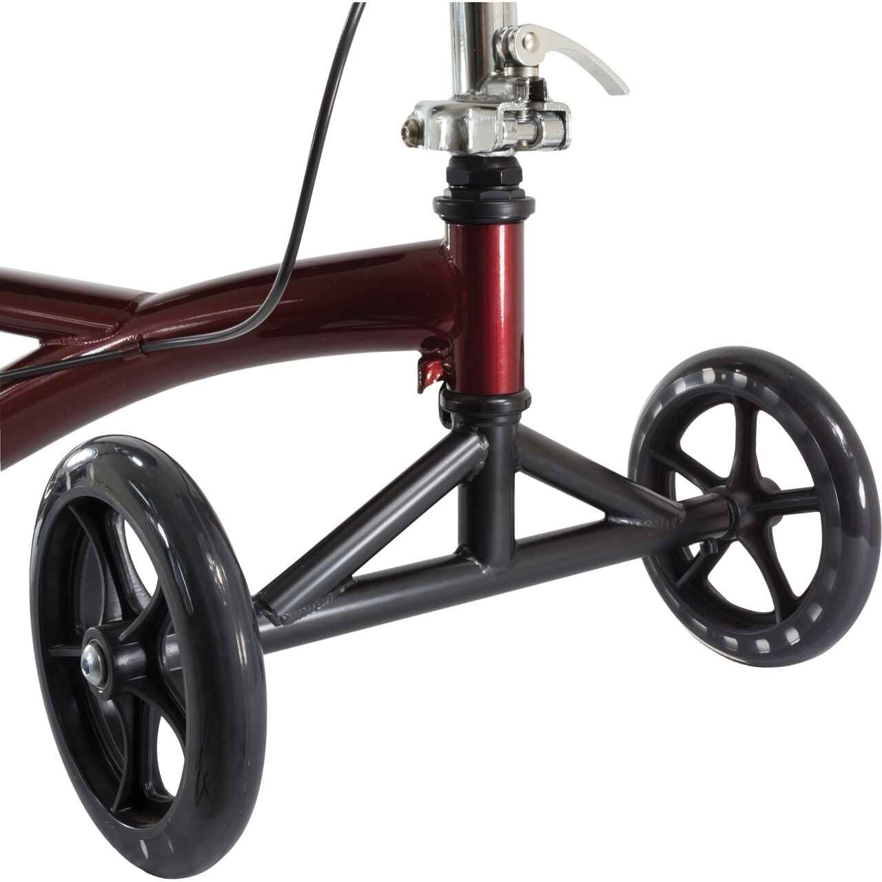 Detail of burgundy knee scooter frame with large black wheels and support bar
