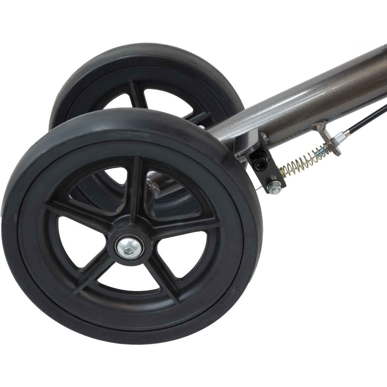 Front wheel and caster on a knee scooter, showing tire tread and wheel spokes.