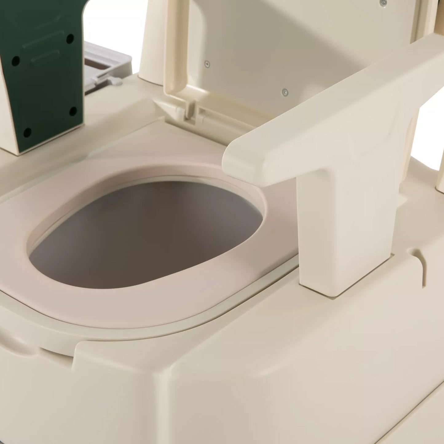 Close-up of commode bowl opening and white rim on adult bedside commode chair