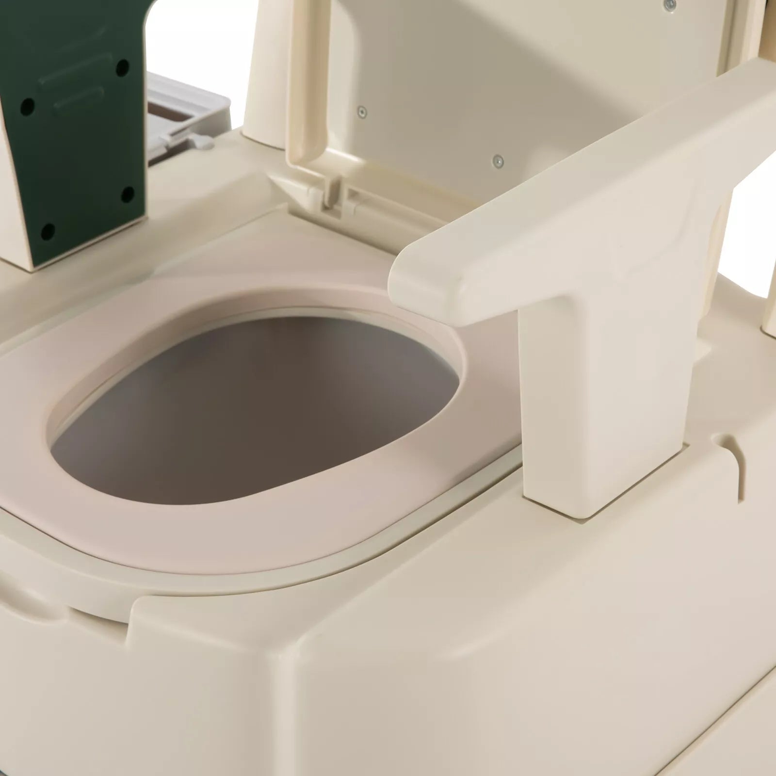 Close-up of commode bowl opening and white rim on adult bedside commode chair