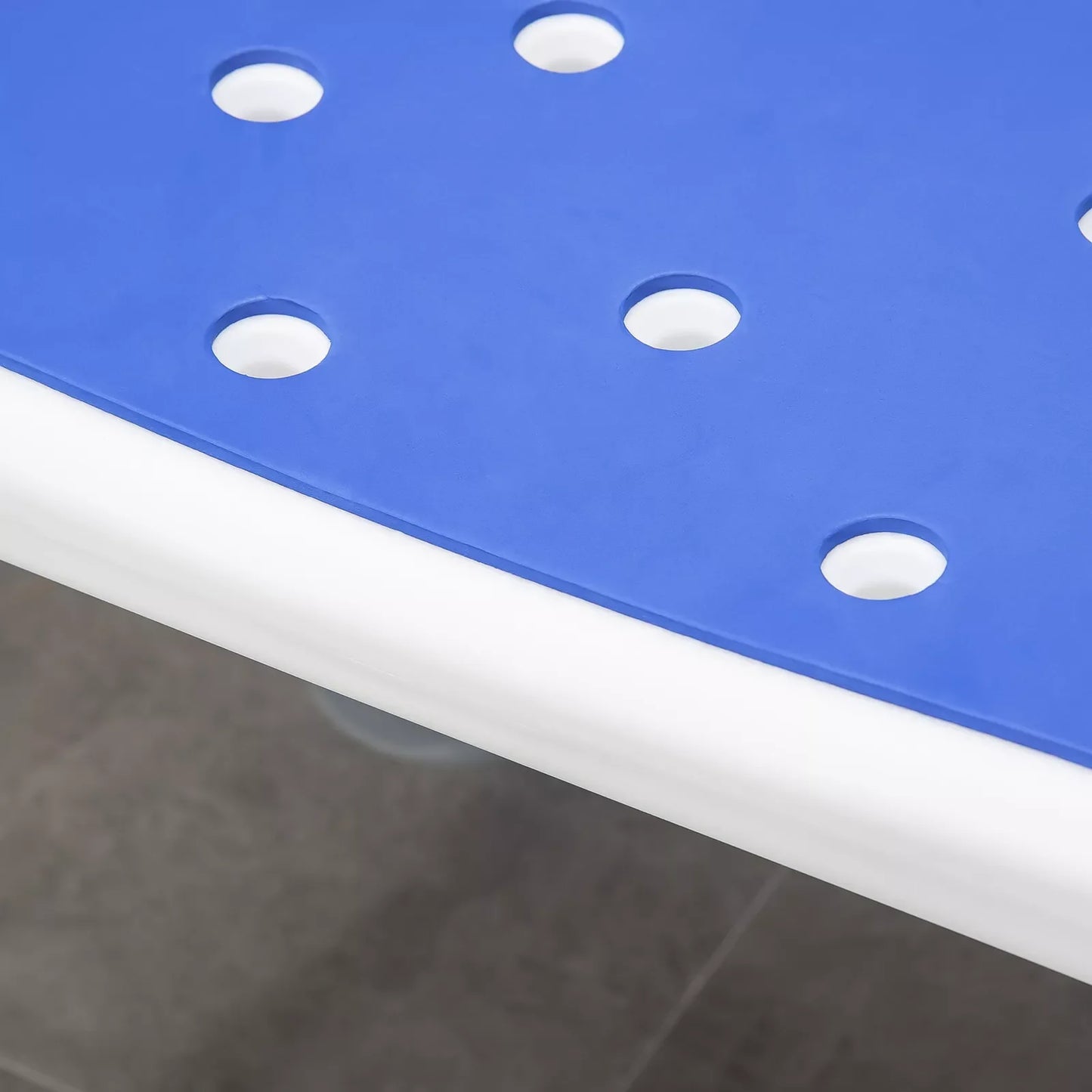 Blue shower chair seat with evenly spaced oval drainage holes on white base