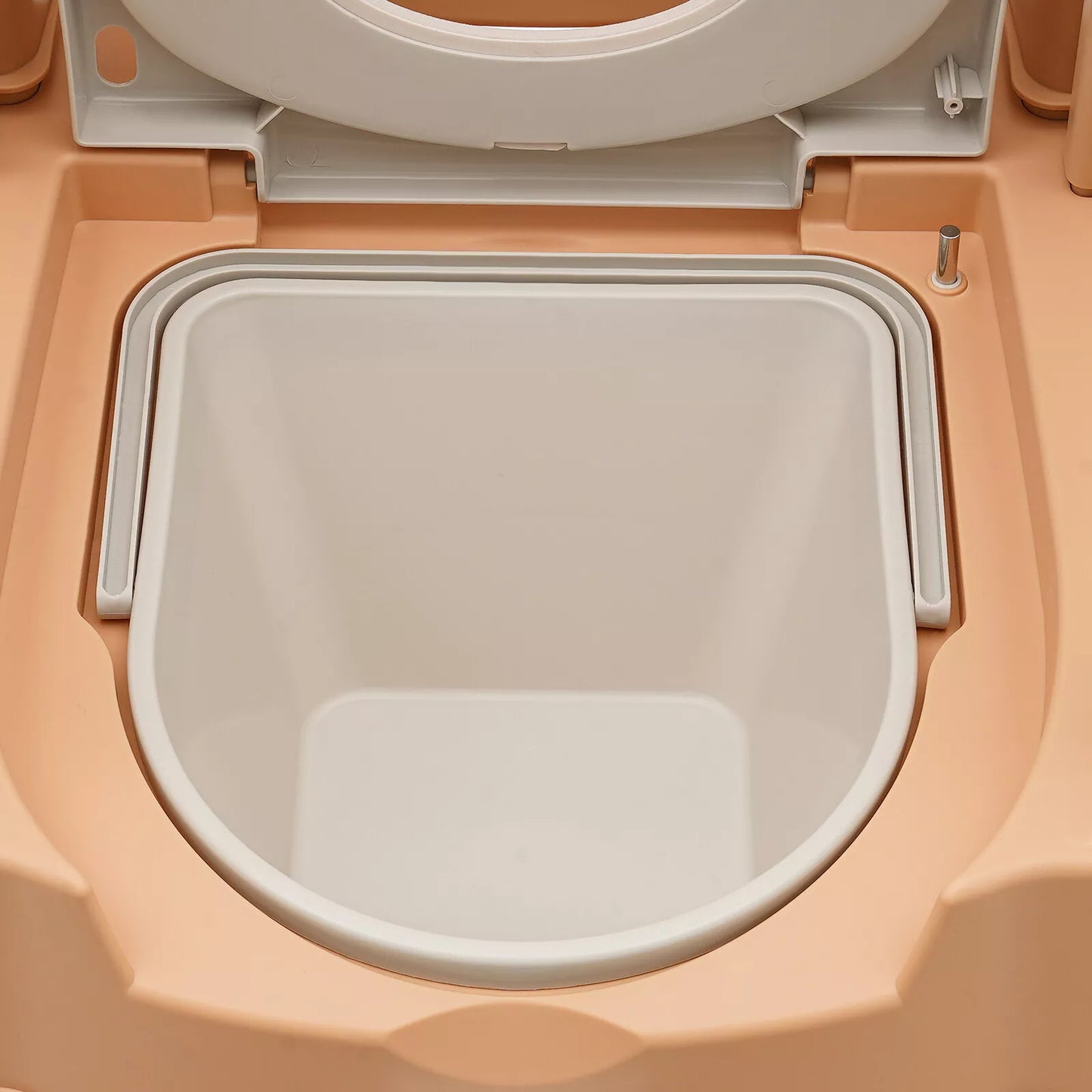 Close-up of khaki commode toilet seat lid opening and inner white basin
