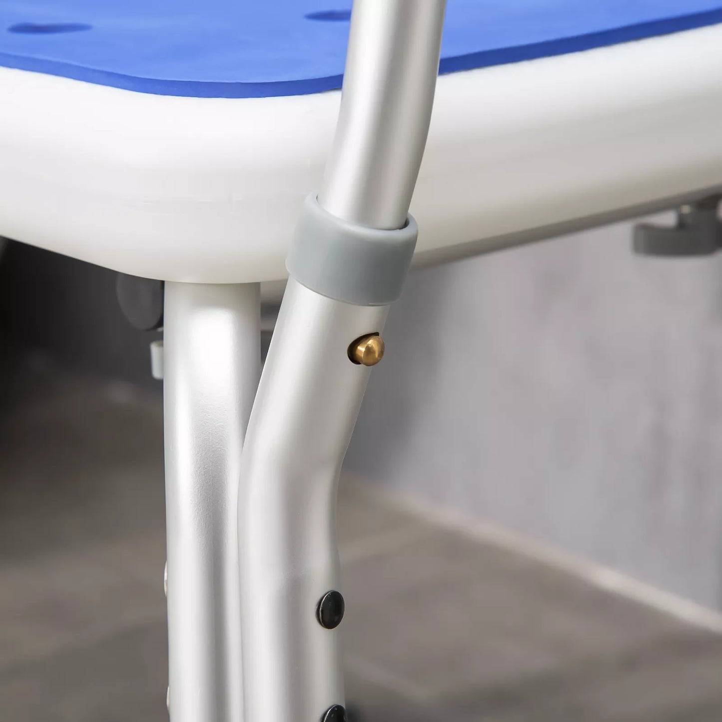 Shower chair leg joint with gold-toned pin and grey suction foot pad