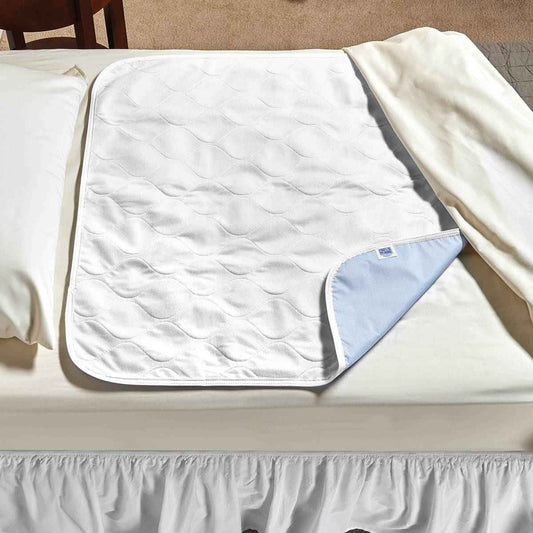 Quilted white underpad with light-blue backing and piped edge, folded for storage