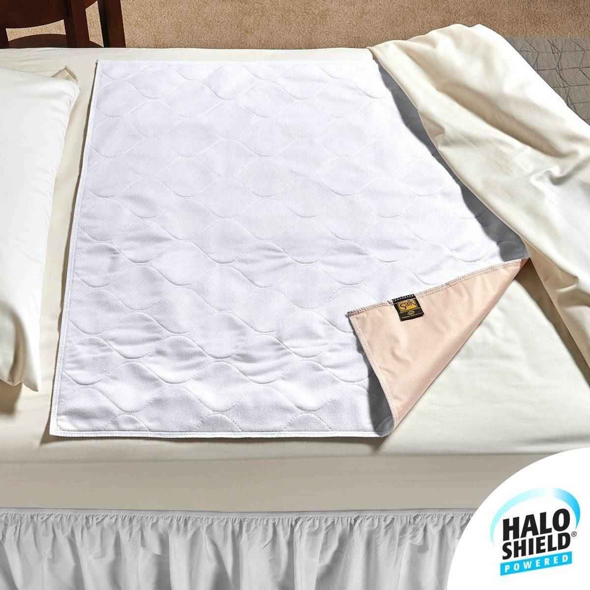 White quilted underpad with pink backing corner tag and folded edge