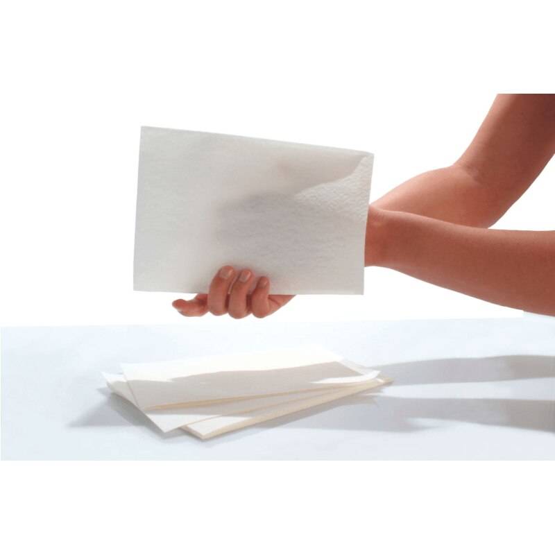 Personal care gloves sheets, white disposable gloves held in hand