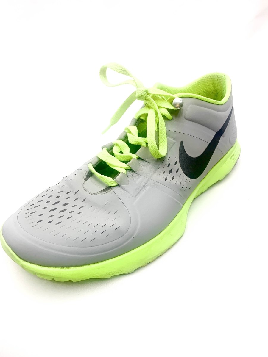 Grey athletic shoe with neon green laces, dark swoosh, and bright green outsole