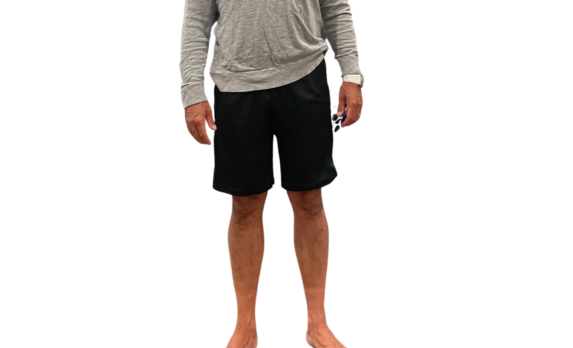 Person wearing a gray long-sleeve shirt and black shorts on a white background