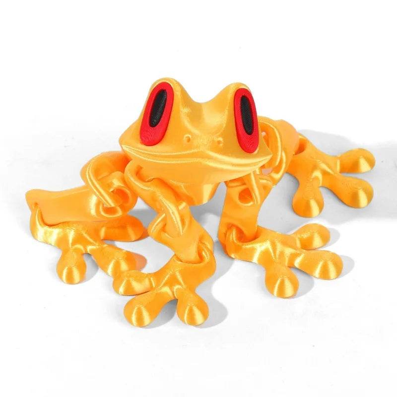 Orange 3D printed magnetic frog toy with red oval eyes and four extended legs.