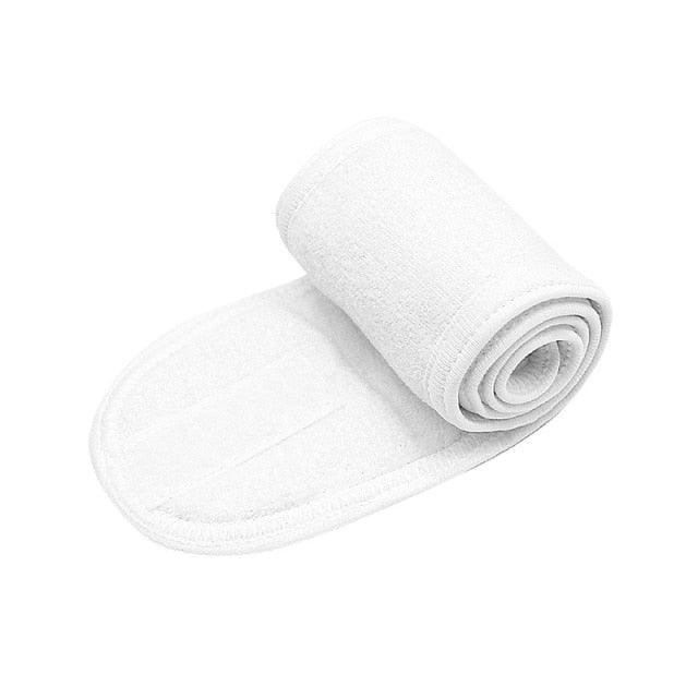 White terry toweling headband, rolled for face washing and makeup.