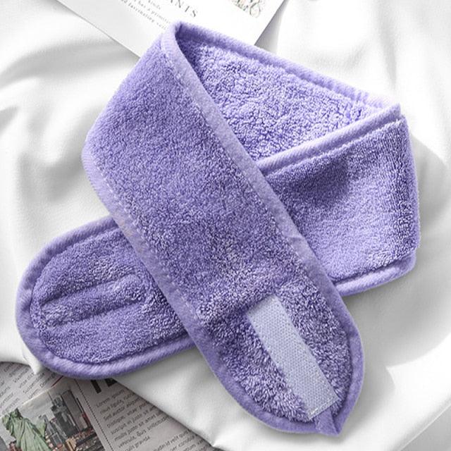 Purple terry cloth face-washing headband with light center stripe and padded band