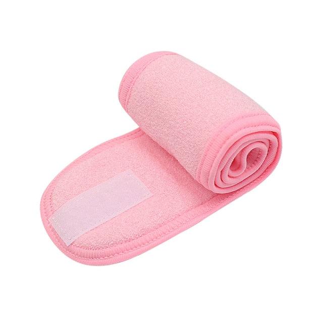 Pink terry cloth facial headband rolled up with wide cushioned band