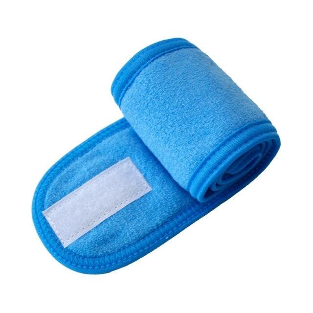 Bright blue terry cloth facial headband with white strap patch
