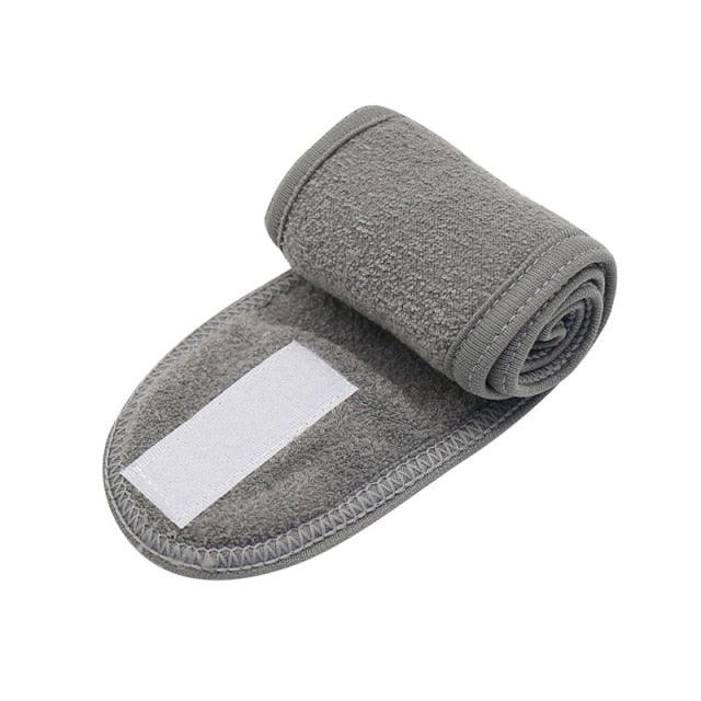 Dark gray terry cloth face-washing headband with white center stripe