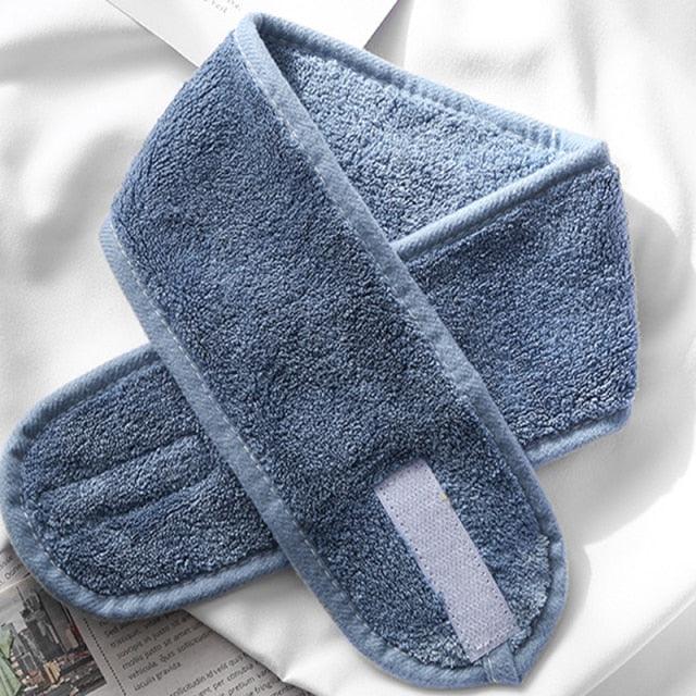 Blue terry cloth facial headband, folded with white strap patch