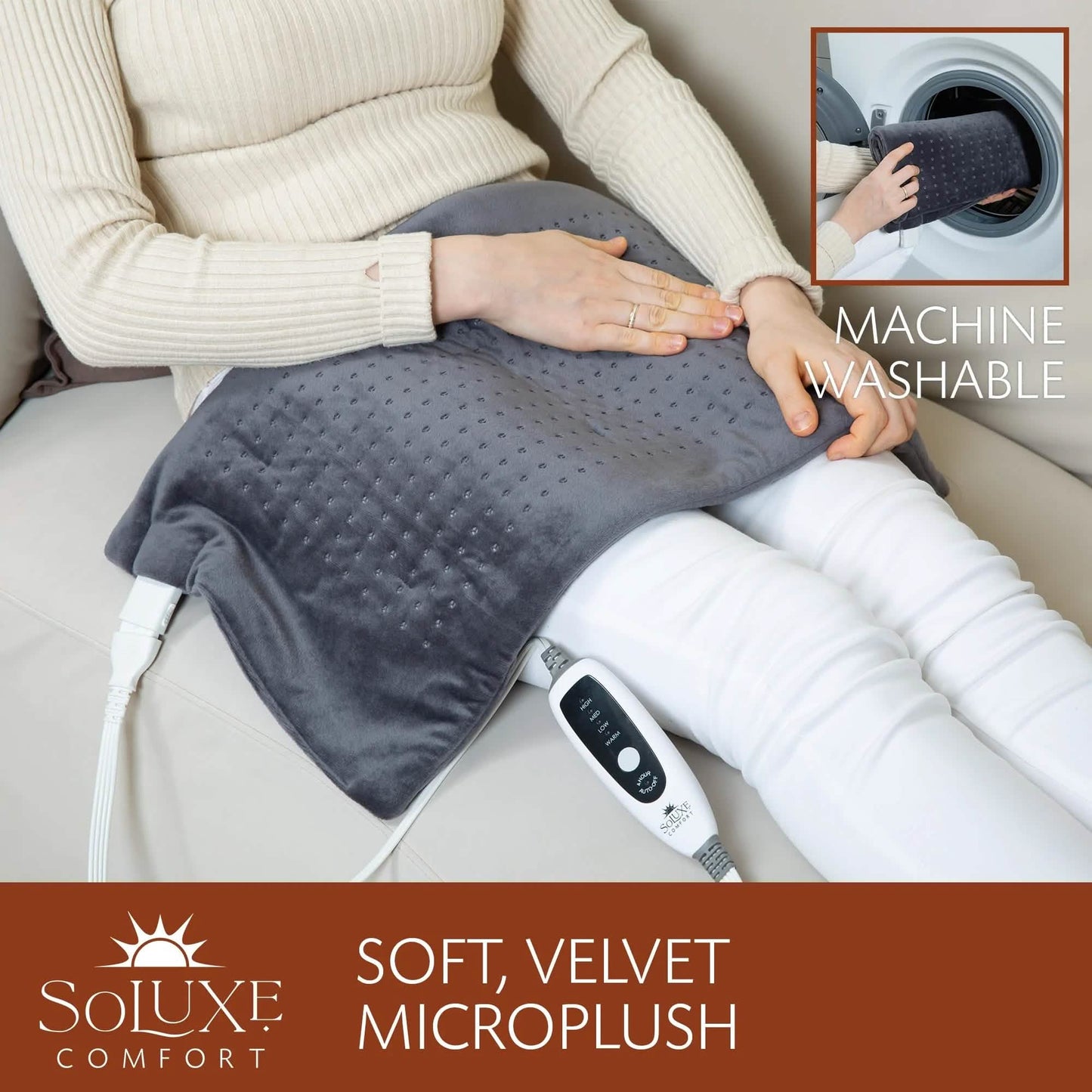 Dark gray heating pad on sofa next to legs with controller cable visible