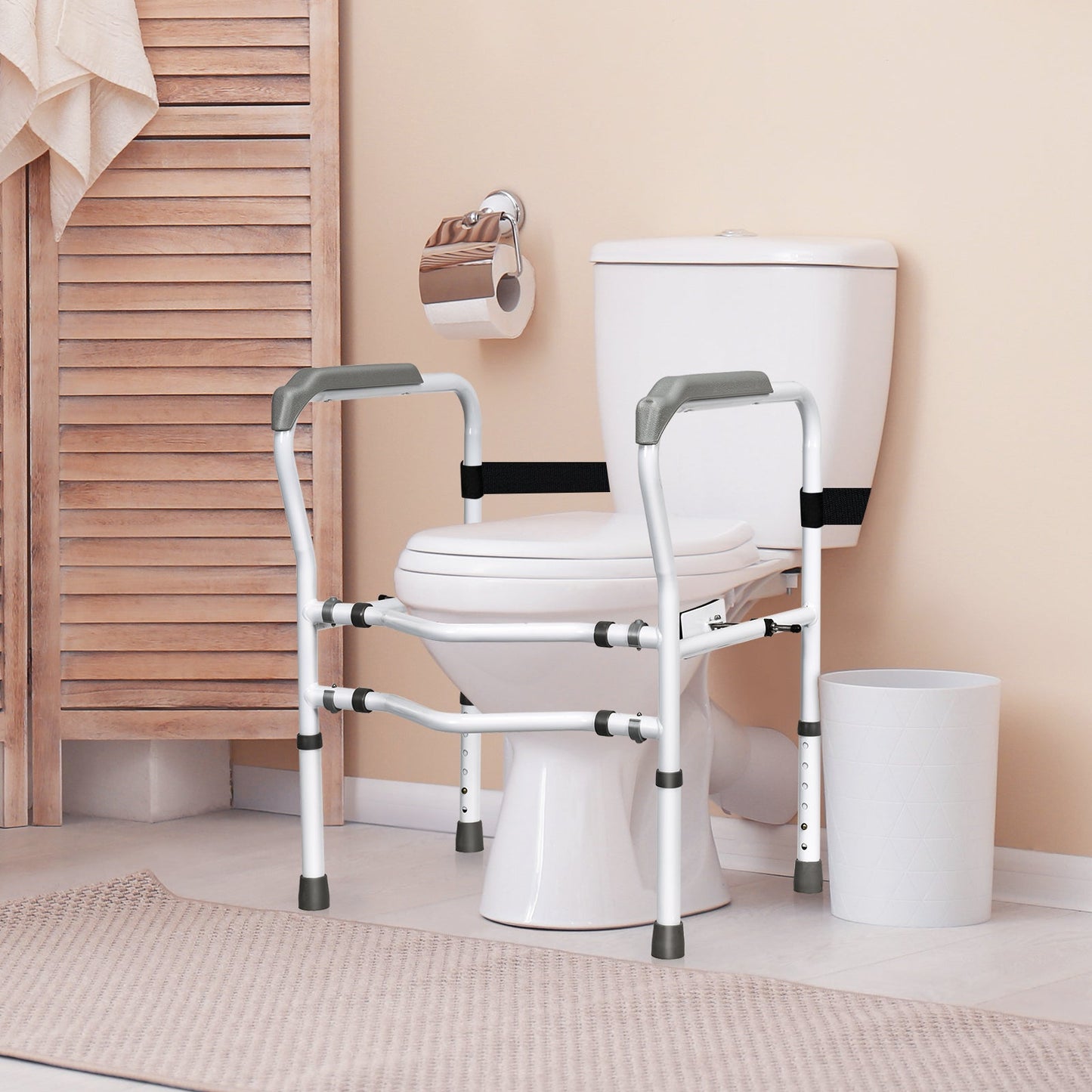 Toilet safety rail with padded armrests, white frame, and black stabilizing strap
