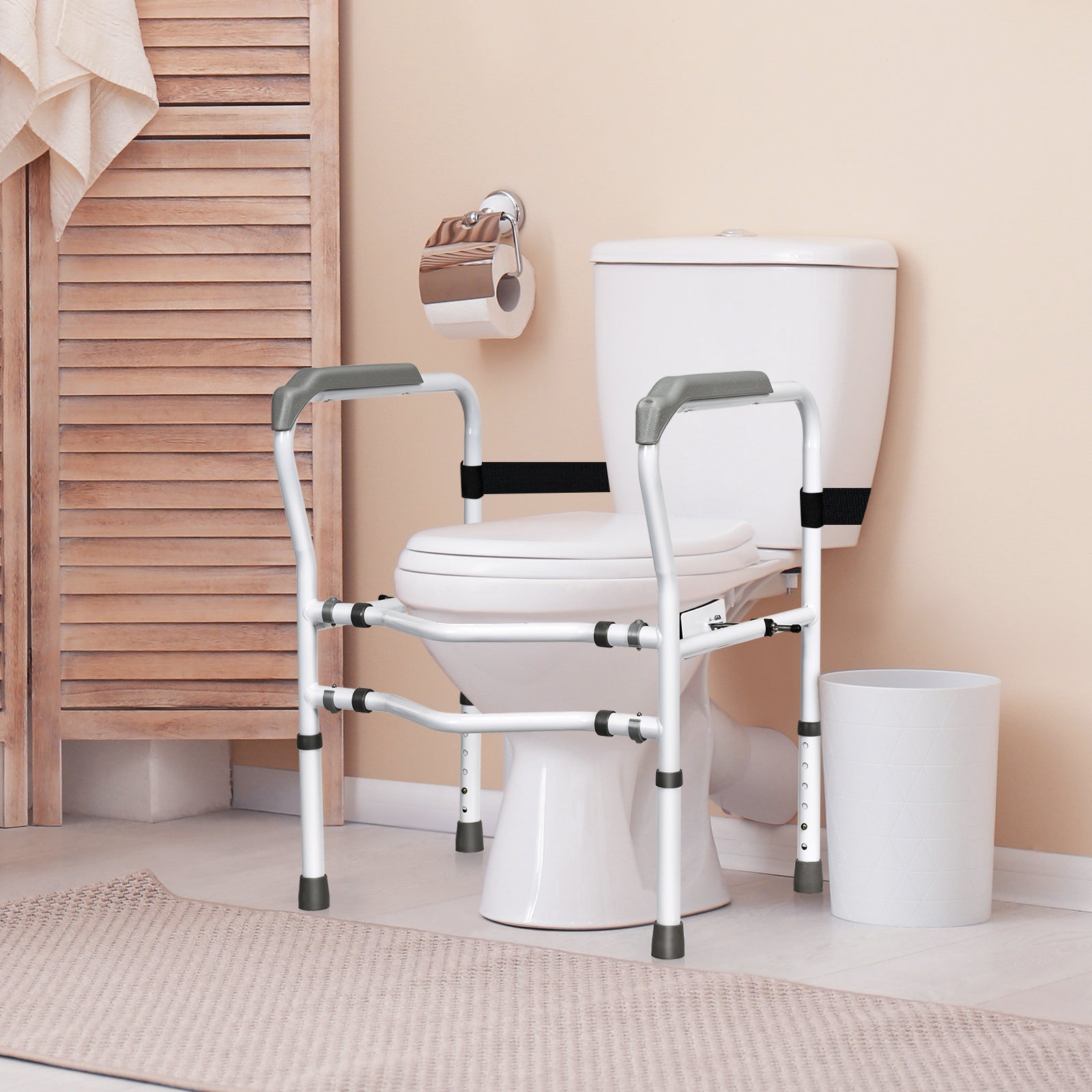 Toilet safety rail with padded armrests, white frame, and black stabilizing strap