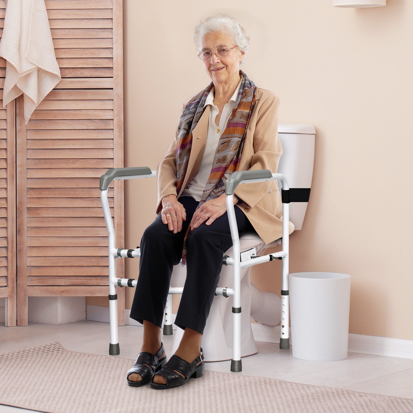 Toilet safety rail with padded armrests shown next to seated person