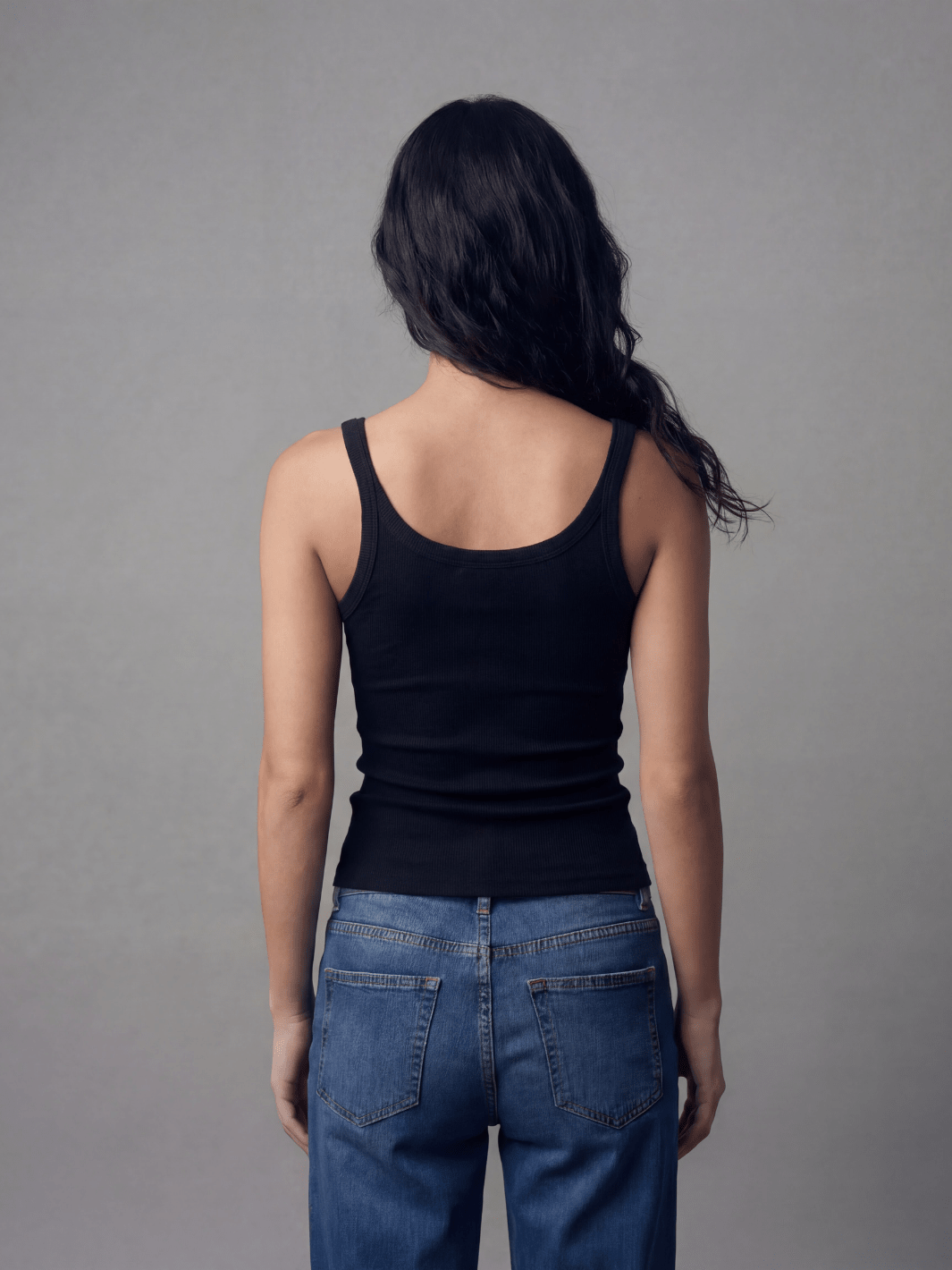 Black spaghetti tank with thin straps and scoop back, fitted ribbed knit