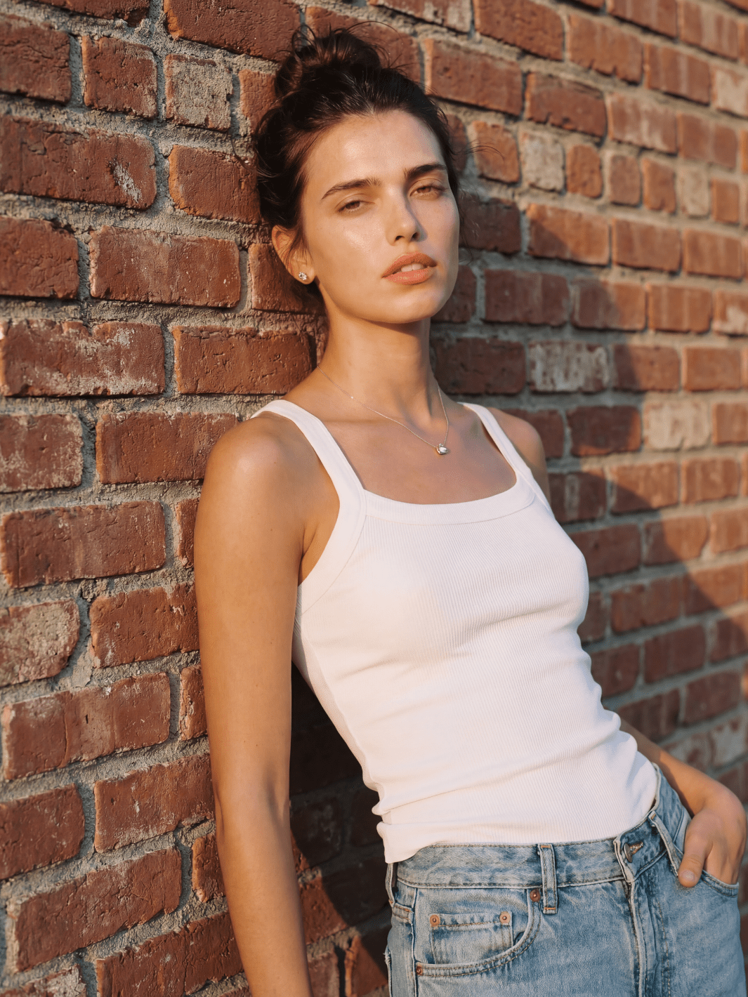 White fitted spaghetti tank with thin straps and scoop neckline, ribbed knit