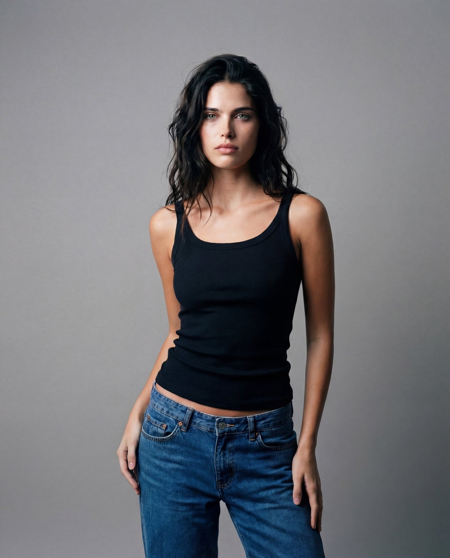 Black spaghetti tank top with thin straps and scoop neckline, fitted ribbed knit
