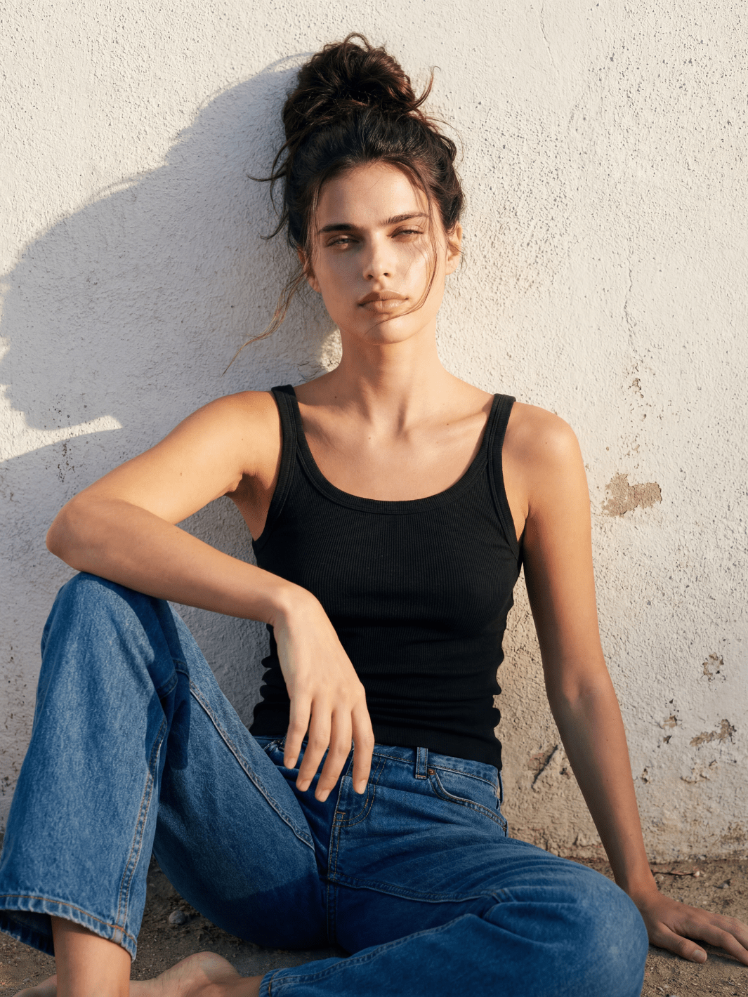 Black fitted spaghetti tank with thin straps and scoop neckline, ribbed knit
