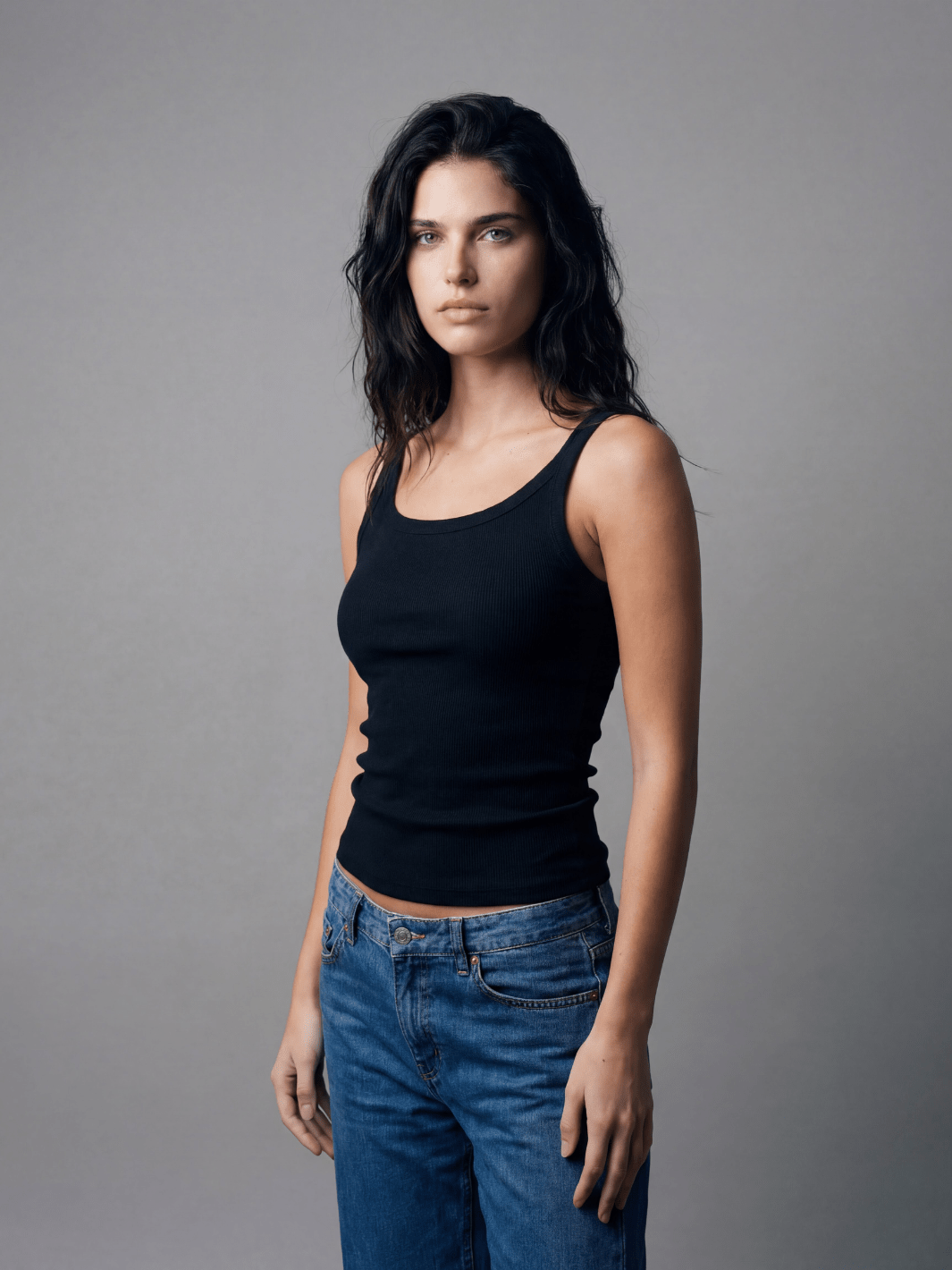 Black fitted spaghetti tank with thin straps and scoop neckline, ribbed knit front