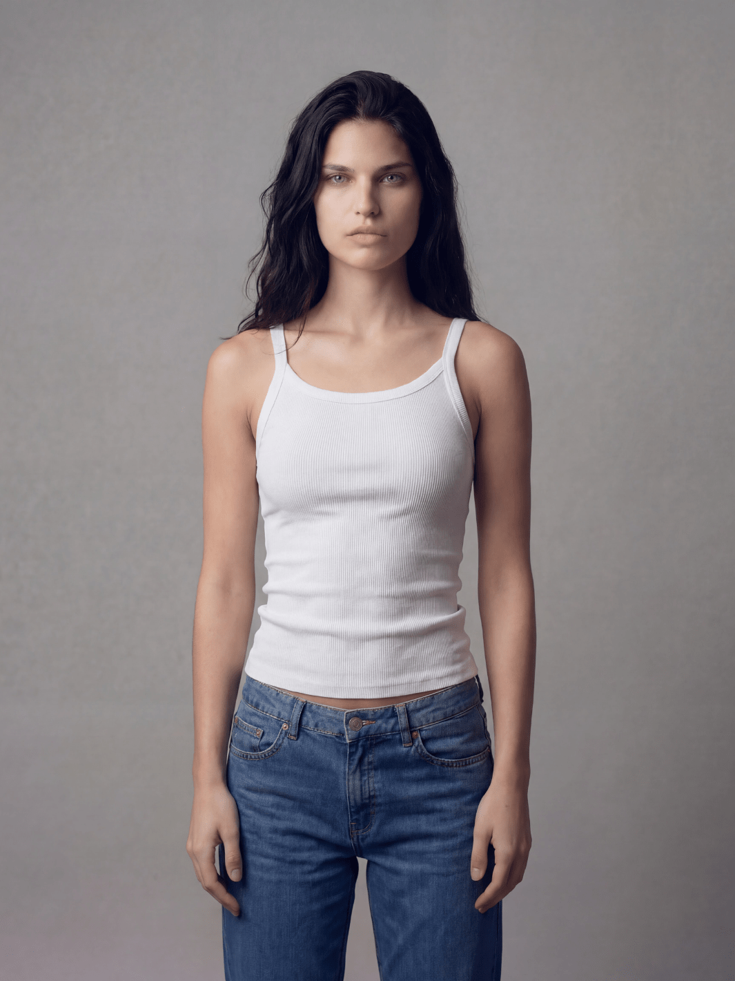 White spaghetti tank top with thin straps and scoop neckline, fitted ribbed knit