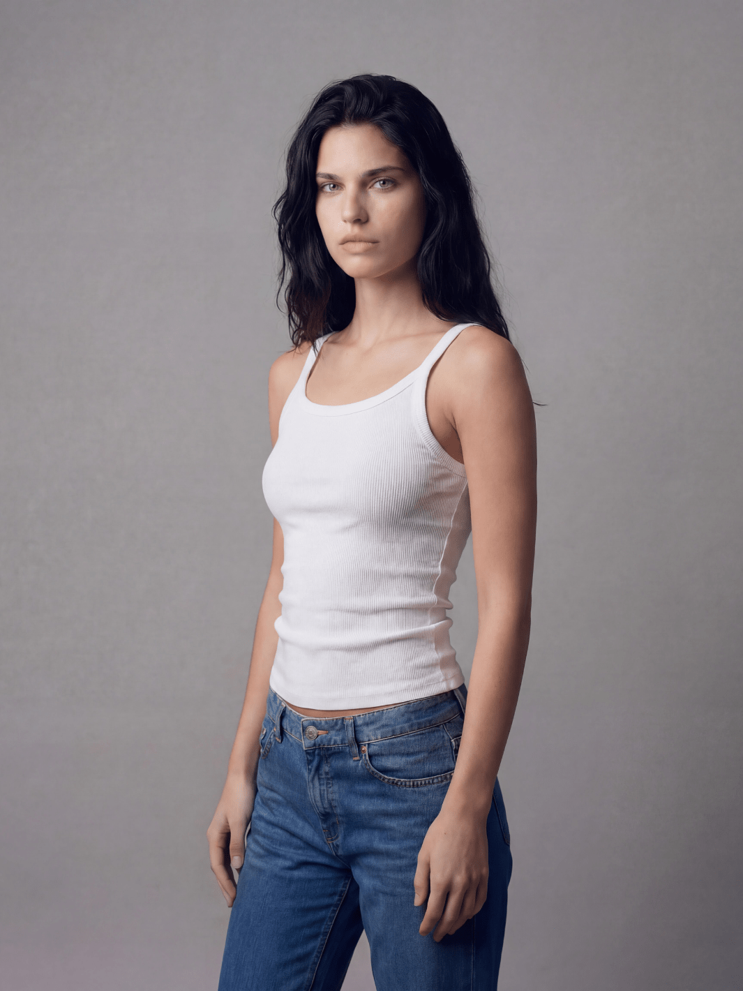 White fitted spaghetti tank with thin straps and scoop neckline, ribbed knit side