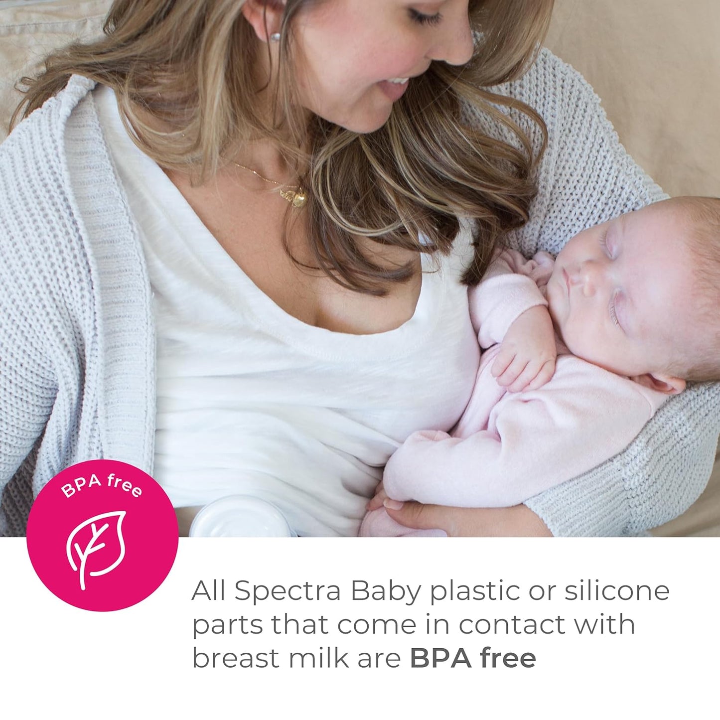 Mother using a manual breast pump with infant, white pump parts at breast