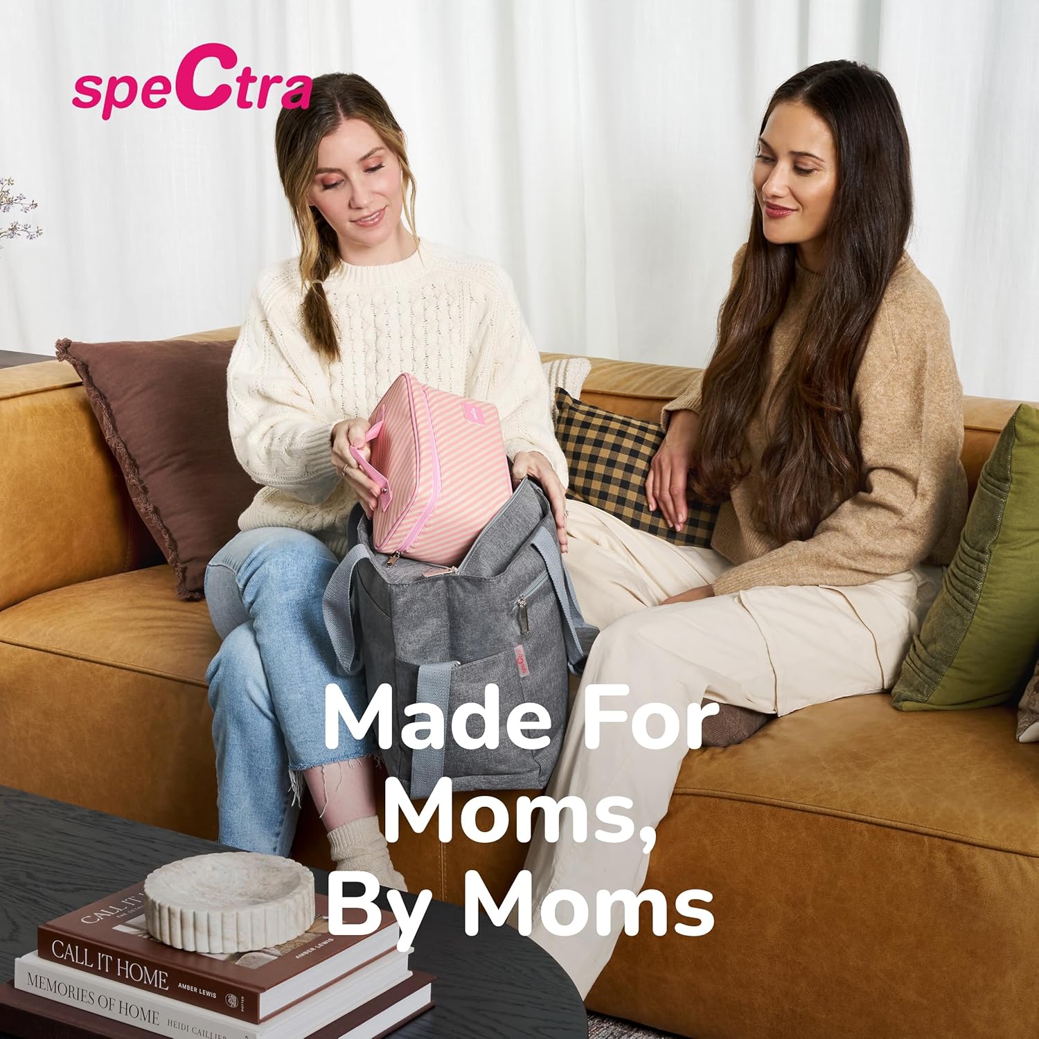 Manual breast pump travel setup in a bag while two people sit on a couch