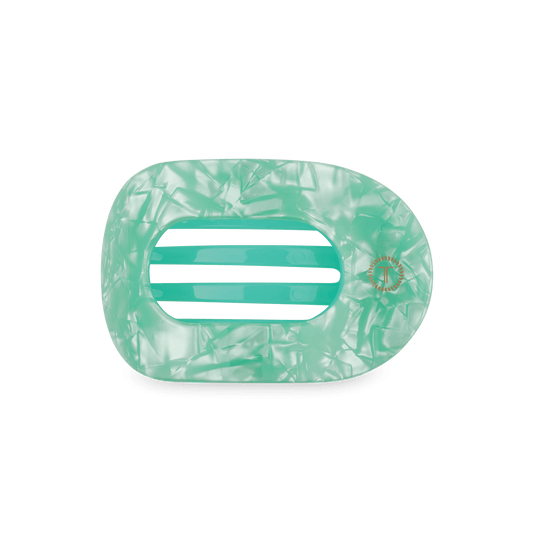 Mint translucent round flat hair clip with two-bar teeth detail and textured swirl pattern
