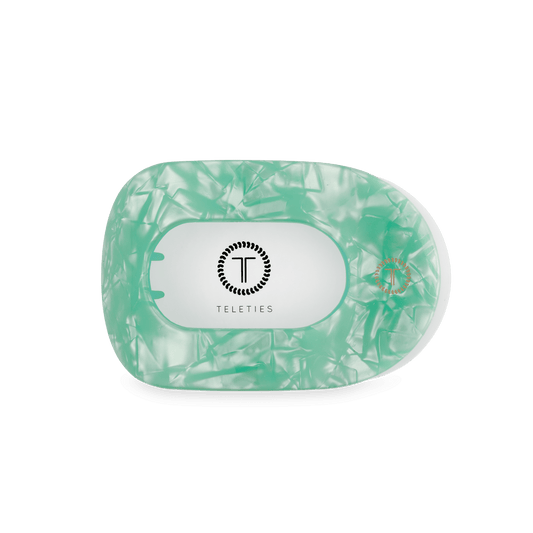 Mint translucent round flat hair clip with oval inner opening and Teleties logo badge