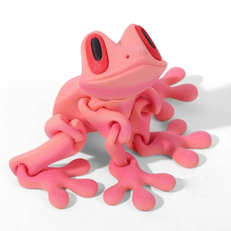 Light pink 3D printed magnetic frog toy with red oval eyes and four extended legs.
