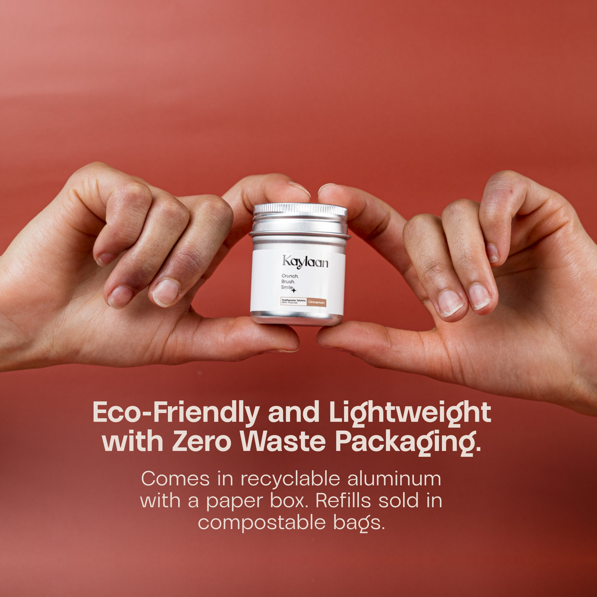 Hands holding a Kaylan fluoride cinnamon toothpaste tablets jar with metal lid