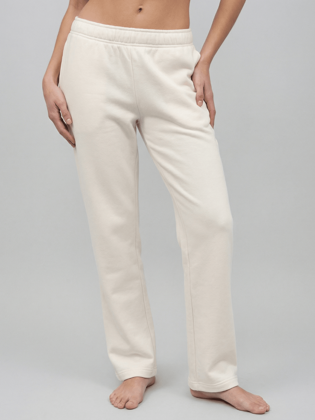 White straight-leg sweatpants with elastic waistband and ankle-length cuffs