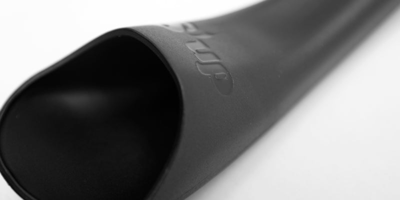 Close-up of black S'up spoon bowl with embossed logo near the handle