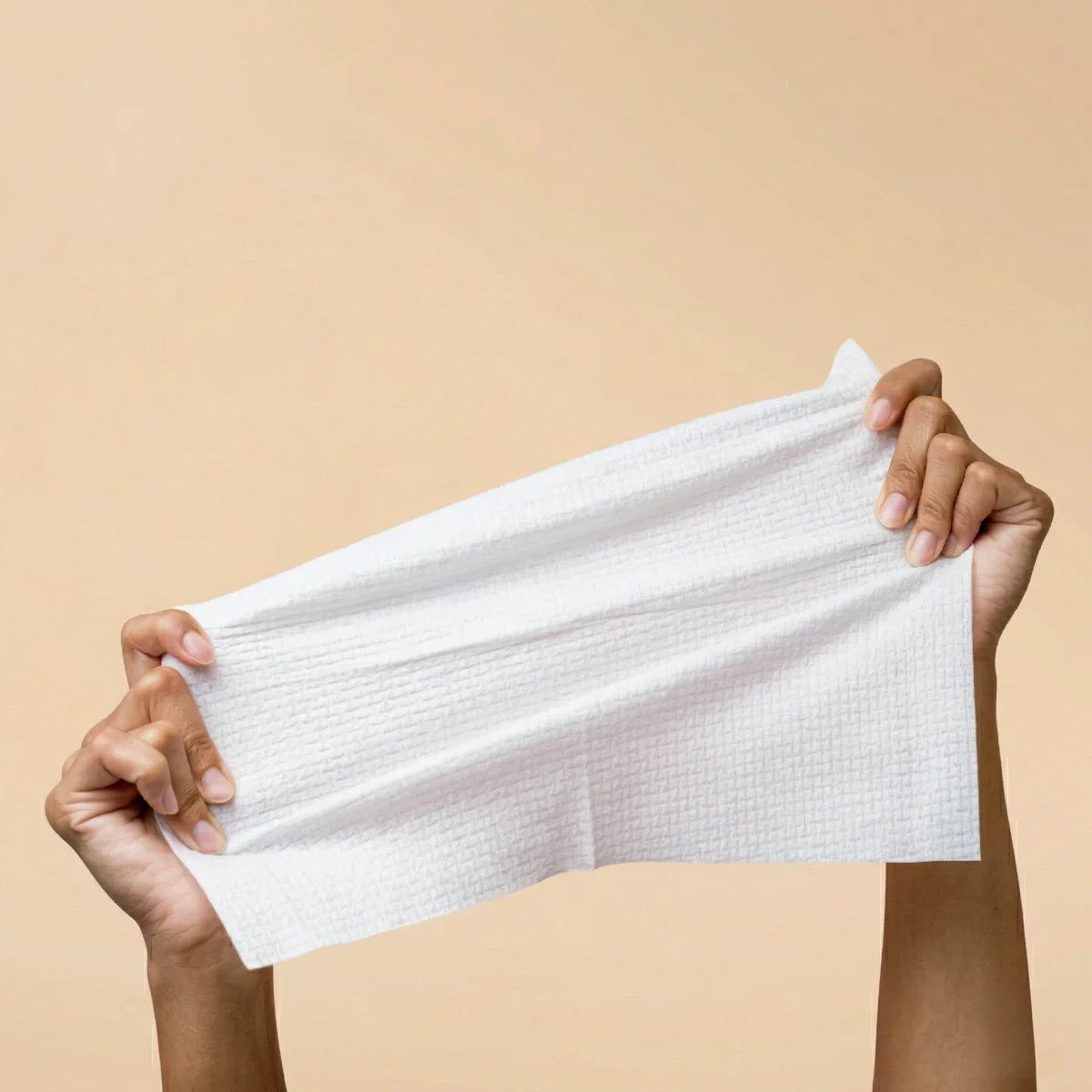 White face towel held horizontally by hands