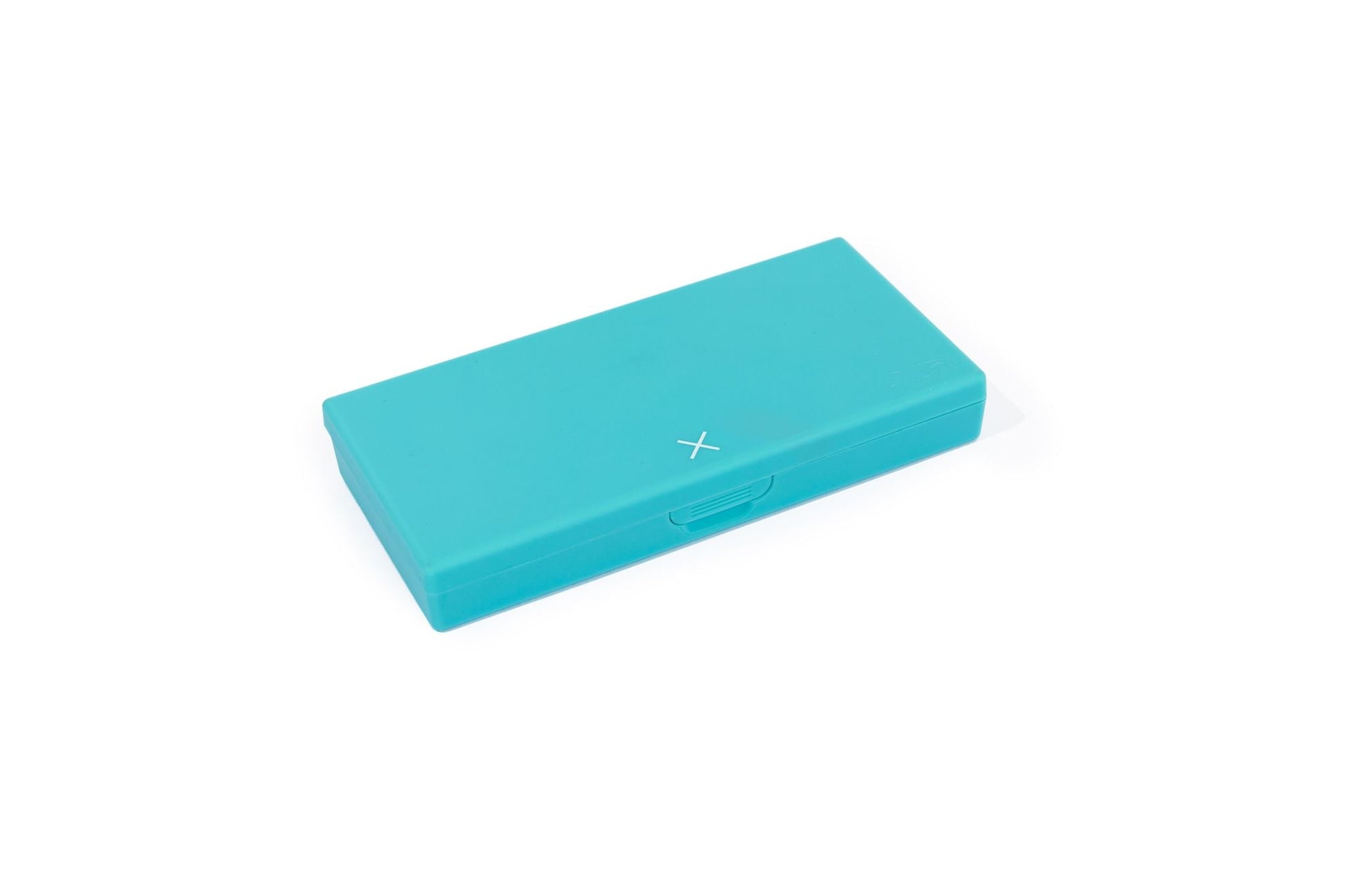 Teal pill box, closed, with small X on side