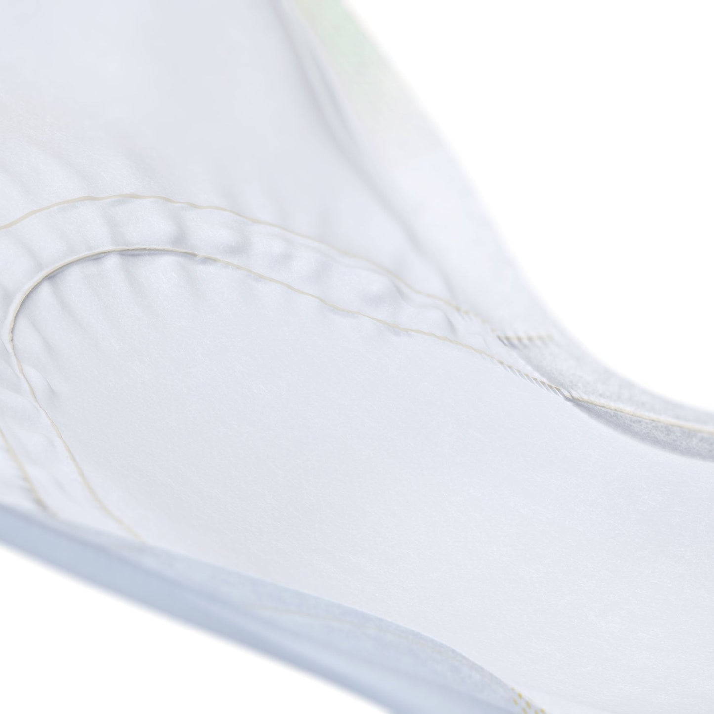 Close-up of white absorbent pad top layer and stitched edges