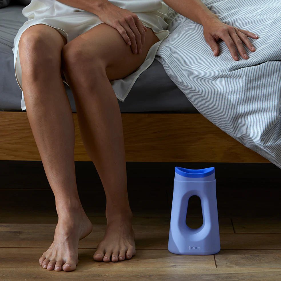 Loona Blue female urinal with closure, placed on floor with oval outlet opening