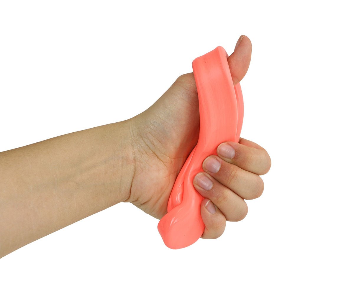 Hand stretching a pink Theraputty resistance putty strip for hand therapy.