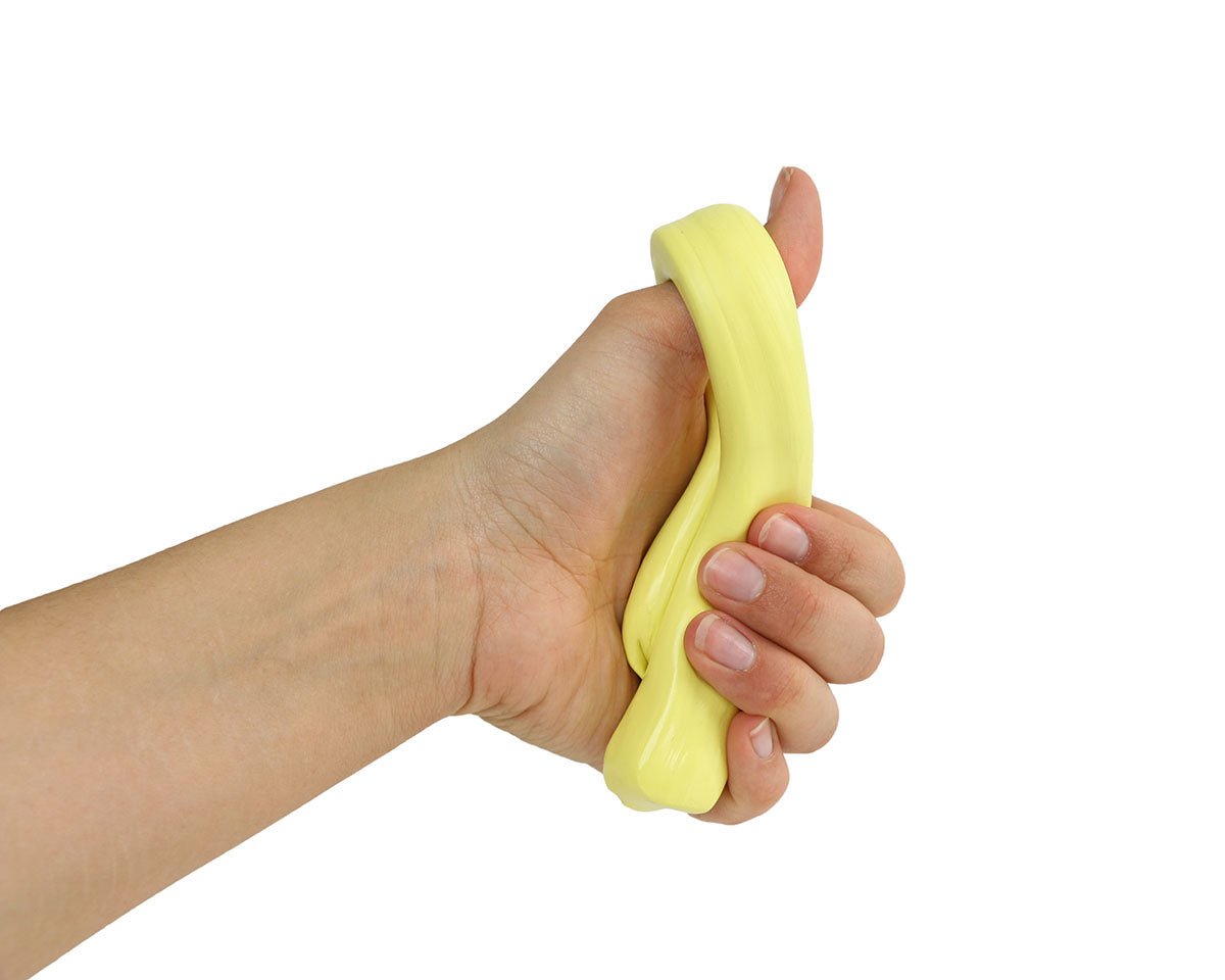 Close view of hand holding a yellow Theraputty resistance putty strip.