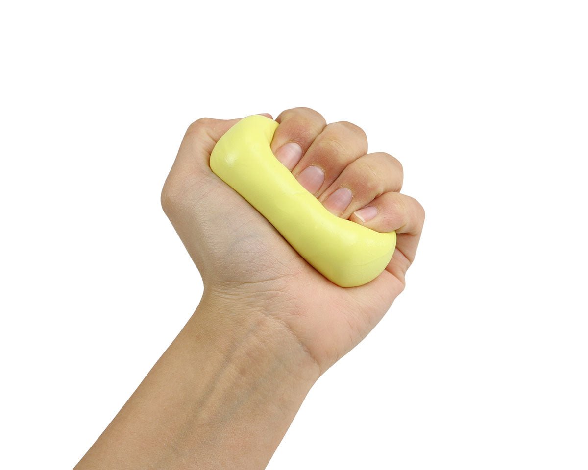 Hand squeezing a yellow Theraputty resistance exercise putty bar.