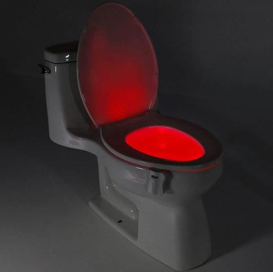 Toilet LED light attachment with red glowing oval on the seat