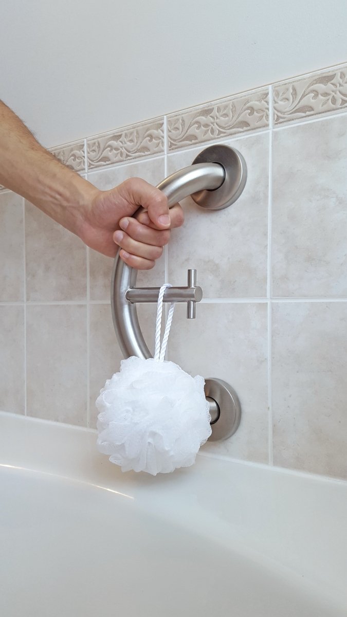 Brushed metal towel and robe hook mounted on wall with hanging cord and item