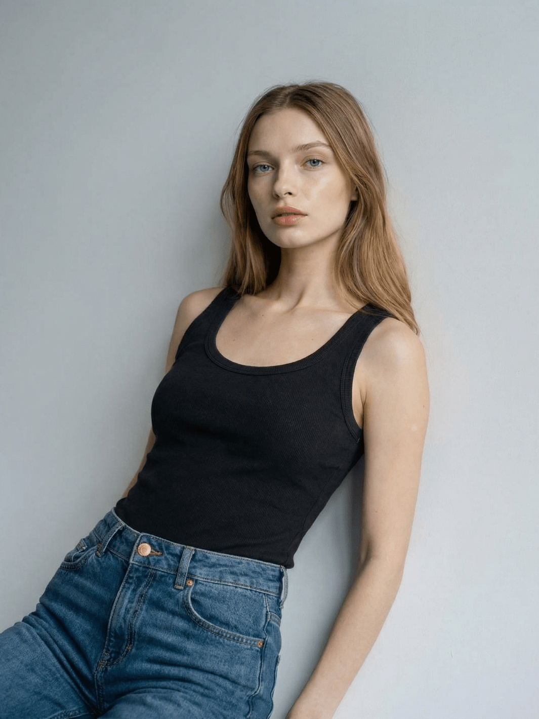 Black ribbed tank top with scoop neck and wide shoulder straps