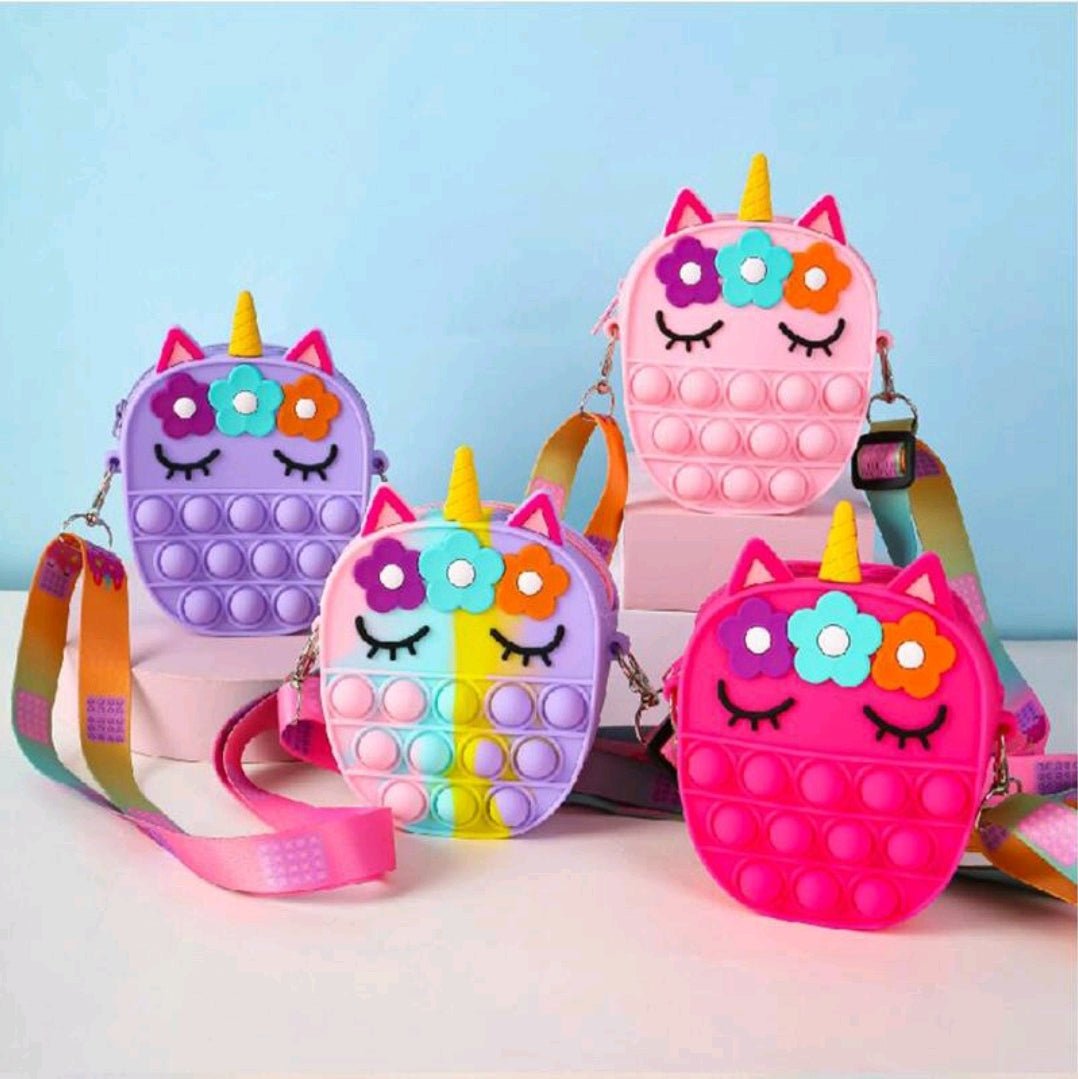 Set of unicorn fidget pop crossbody bags with colorful rainbow straps and flower details