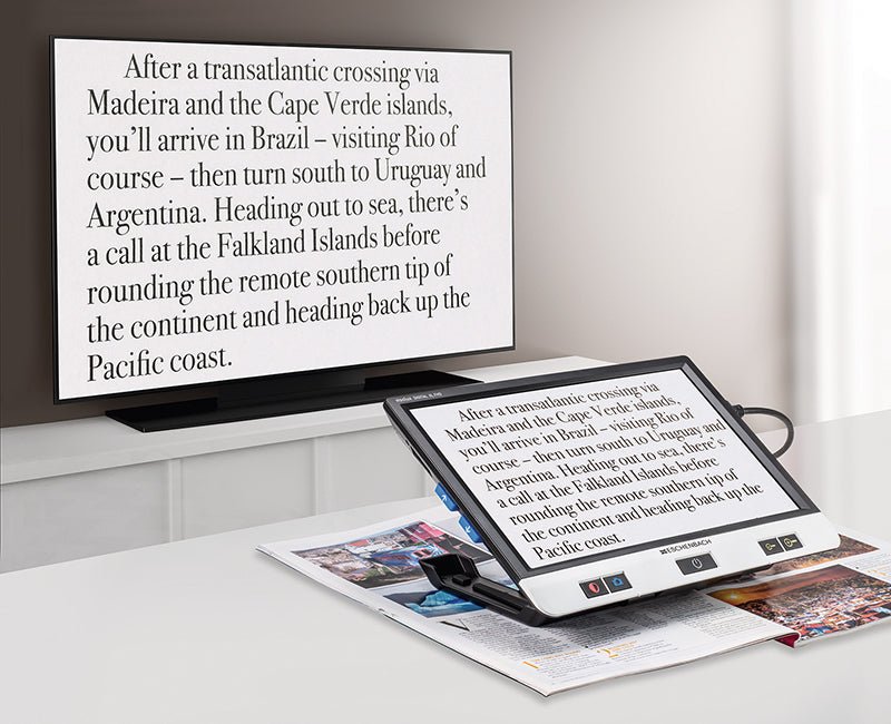 Two angled XL FHD monitors showing travel text on stand with glossy screen
